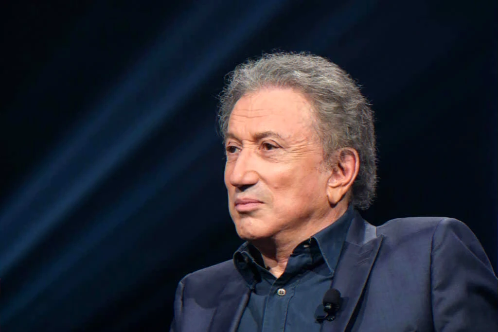 Longtime French television presenter in studio promoting memoir and recounting career anecdotes