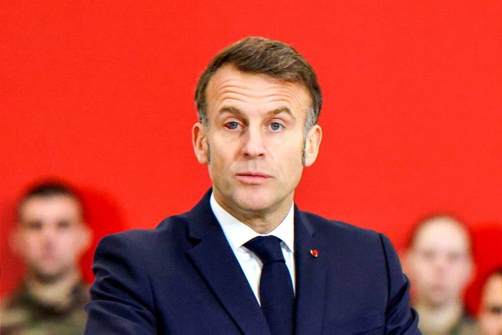 Individual in a suit against a red backdrop illustrating an article about a family photograph that went viral and sparked debate on privacy.