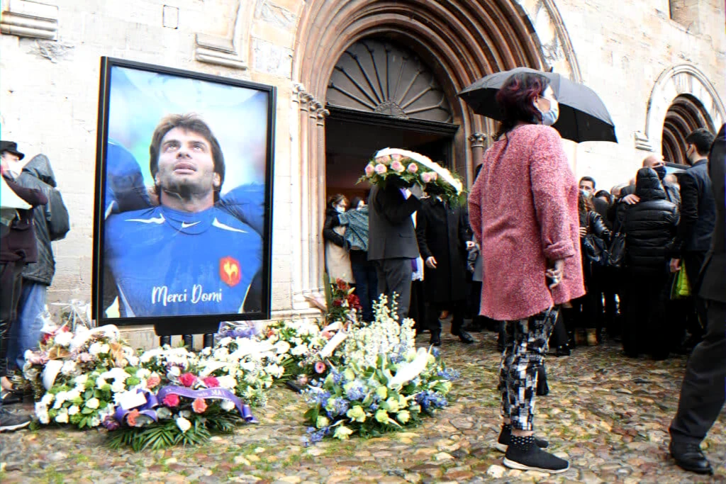 memorial service in Saint-Cloud with floral tributes