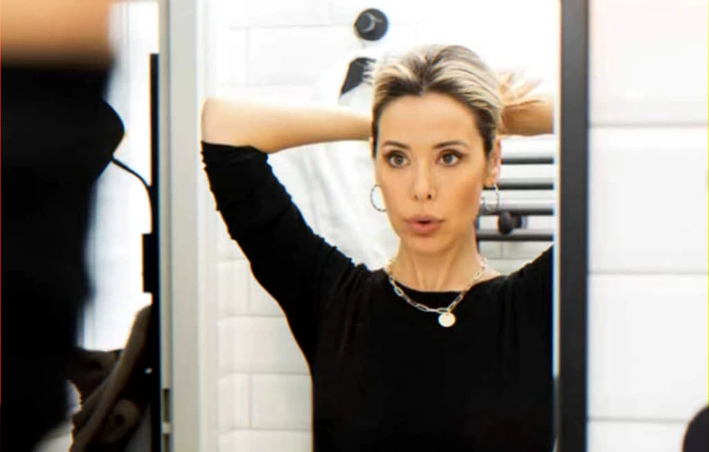 person-in-mirror-preparing-for-ceremony-return-to-studies-article